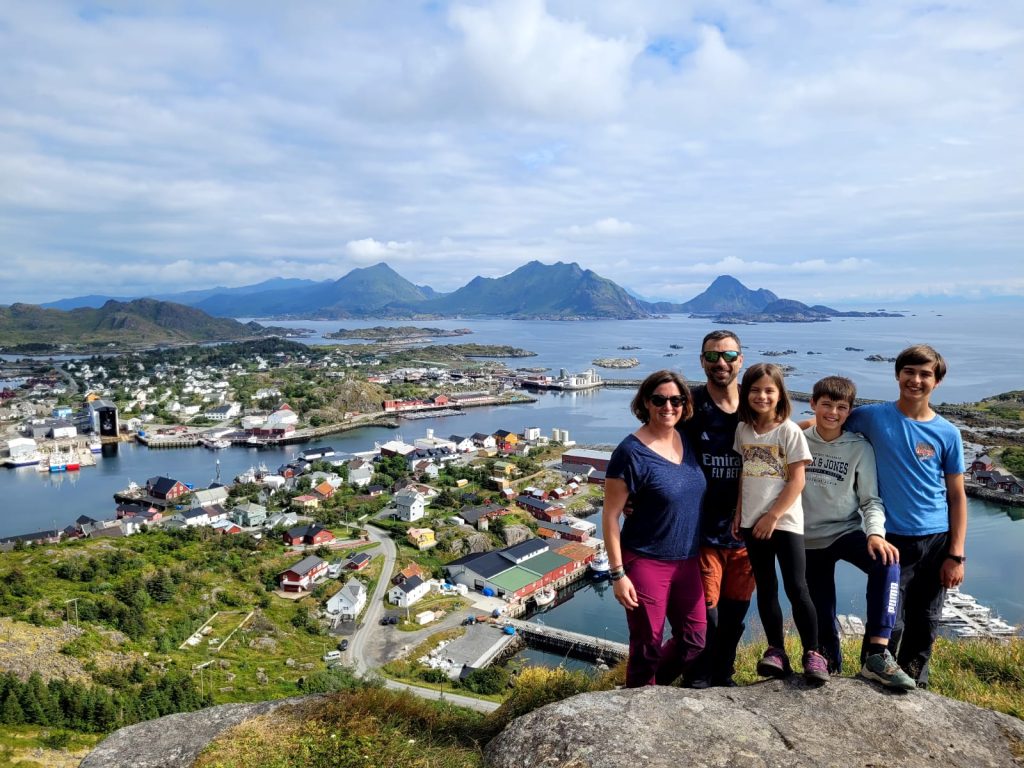Mylène en randonnée en famille, avec vue sur un village côtier et les montagnes